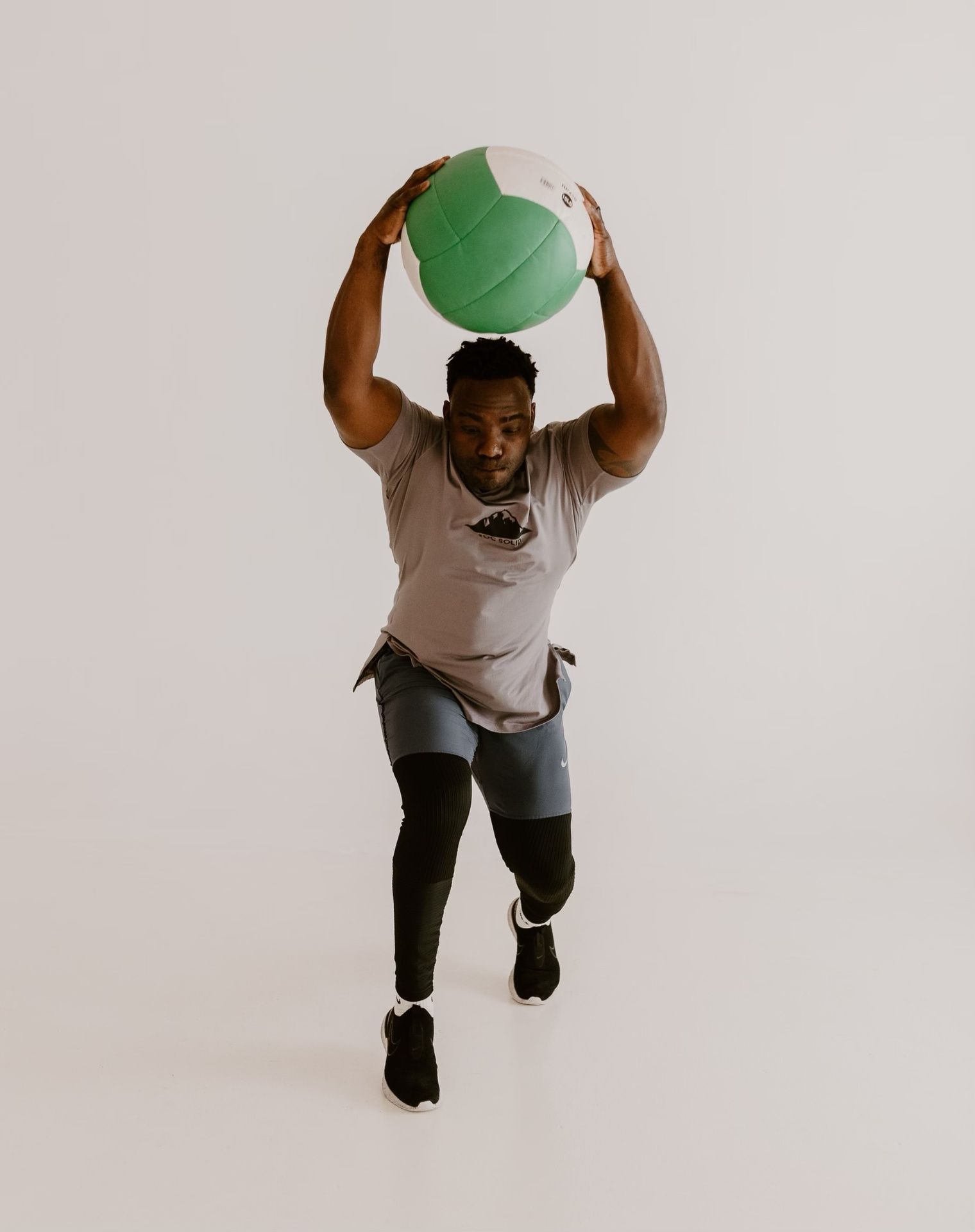 Coach Ben Birmingham demonstrating a dynamic medicine ball exercise at Roc Solid Training in Edmond, OK